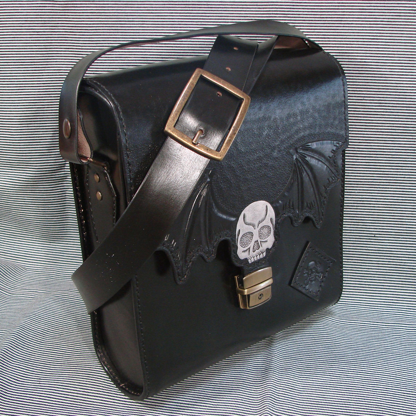Gothic messenger bag in vegetable tanned leather with skull and bat wings
