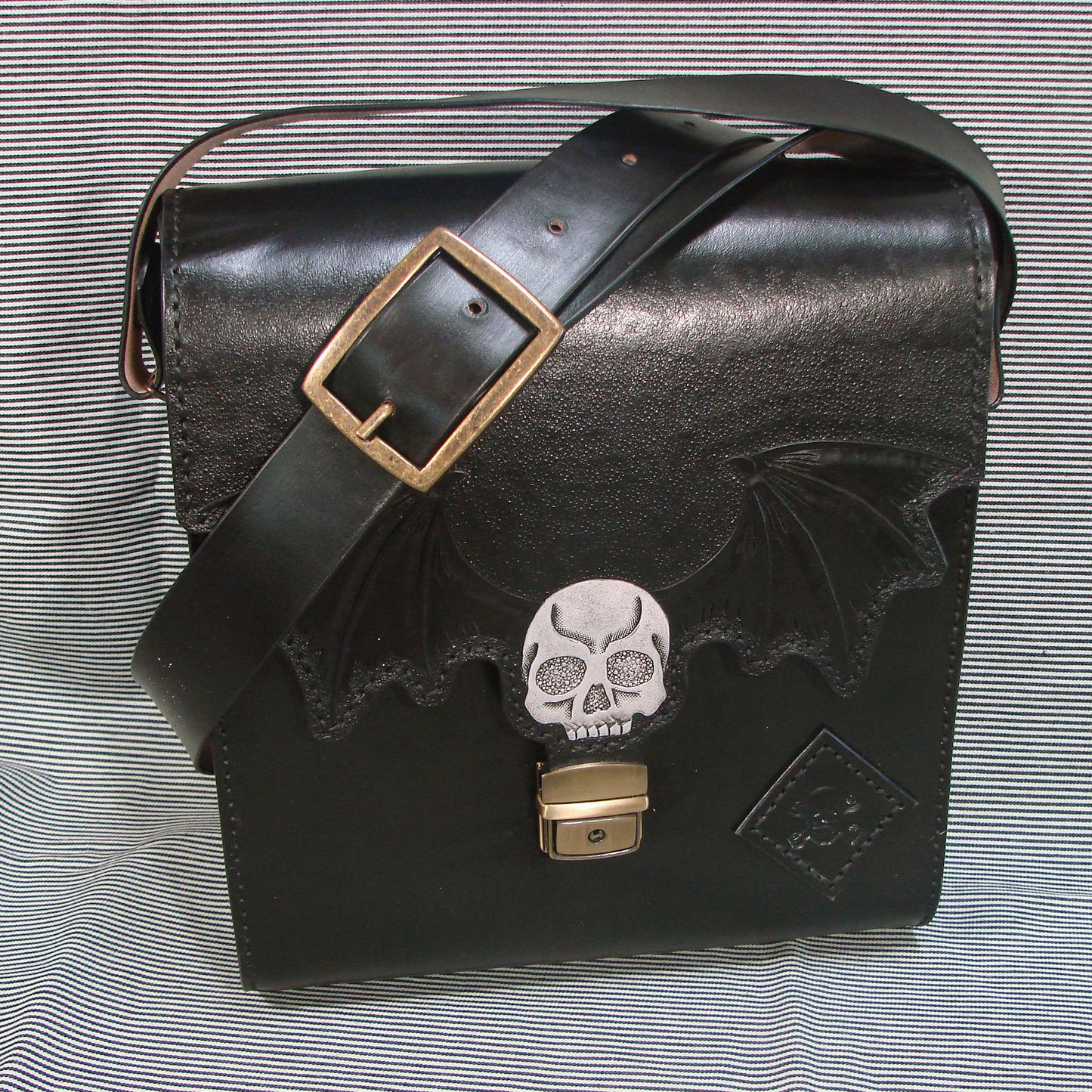 Gothic messenger bag in vegetable tanned leather with skull and bat wings