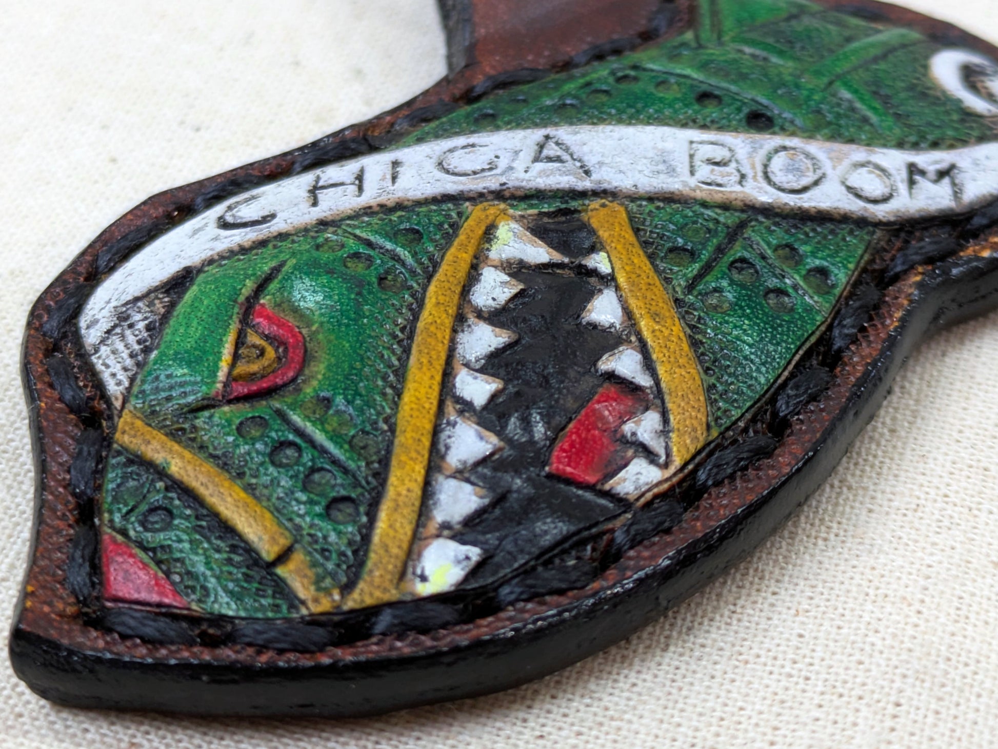 Colorful Bomb Leather Keychain with 'Chica Boom' text on a textured surface