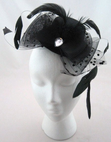 Mini hat with a tulle down feathers and a crystal stone, tightens with two hooksAnother Way of Life