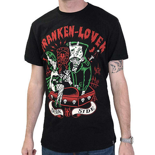 Men's black T-shirt with a colorful illustration of Frankenstein and his bride lying in a coffin decorated with skulls, with the text “FRANKEN-LOVER” in red and green and “DARK SIDE” on a banner with roses.